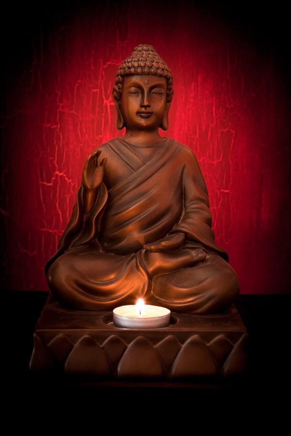 Buddha statue with a candle on a red background - Image 2