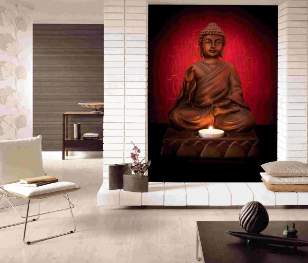 Buddha statue with a candle on a red background