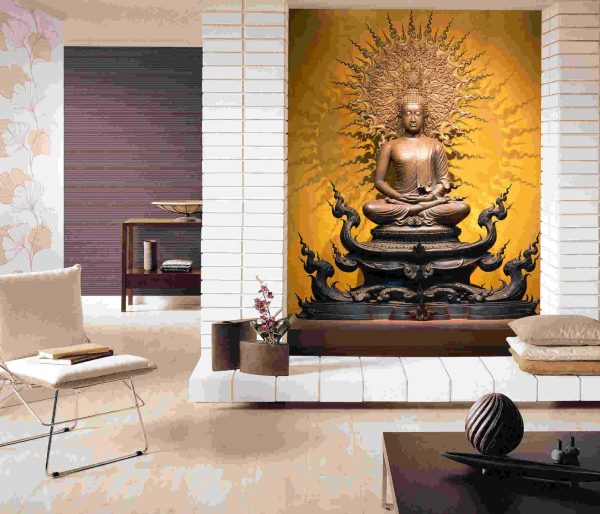 Golden Buddha sculpture in lotus position sitting on an orange background