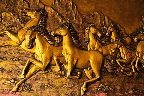 Golden Horses sculptures on the wall