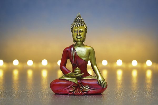 Buddha figure with candle lights in row