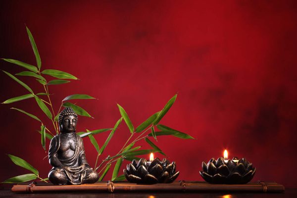 Buddha in meditation with burning candle and bamboo leaf on red background. - Image 2